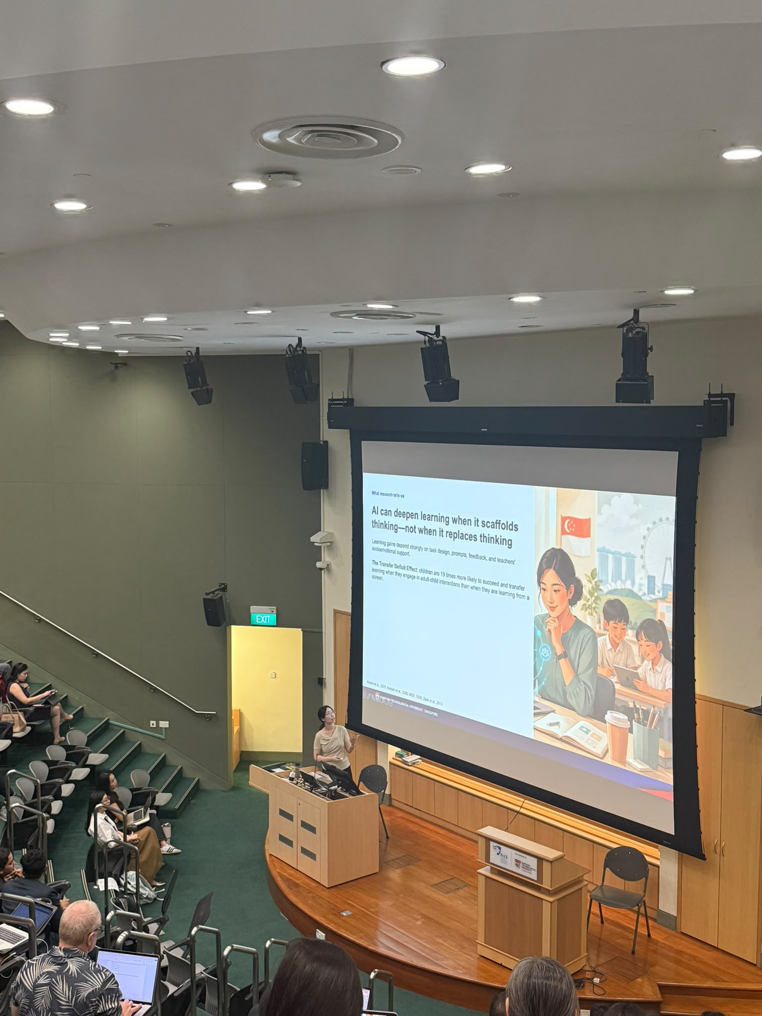 Jiawen Wu presenting in a lecture hall beside a slide explaining how AI can deepen learning when it scaffolds rather than replaces thinking.